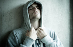 man with hoodie up has crack Addiction