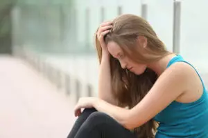 sad woman considers going to a rehabilitation center