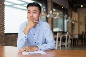 man sitting at coffee shop considers mindfulness training