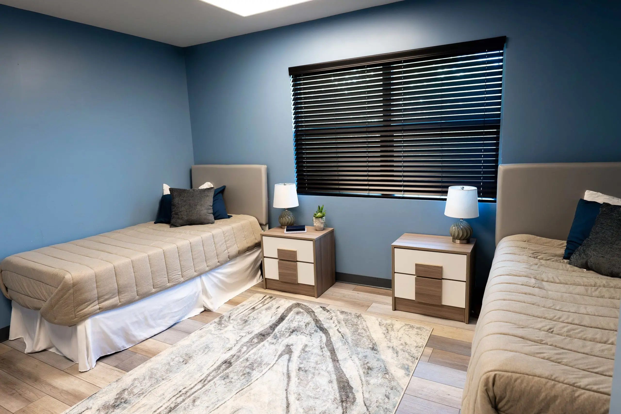 two beds in a bedroom at residential facility